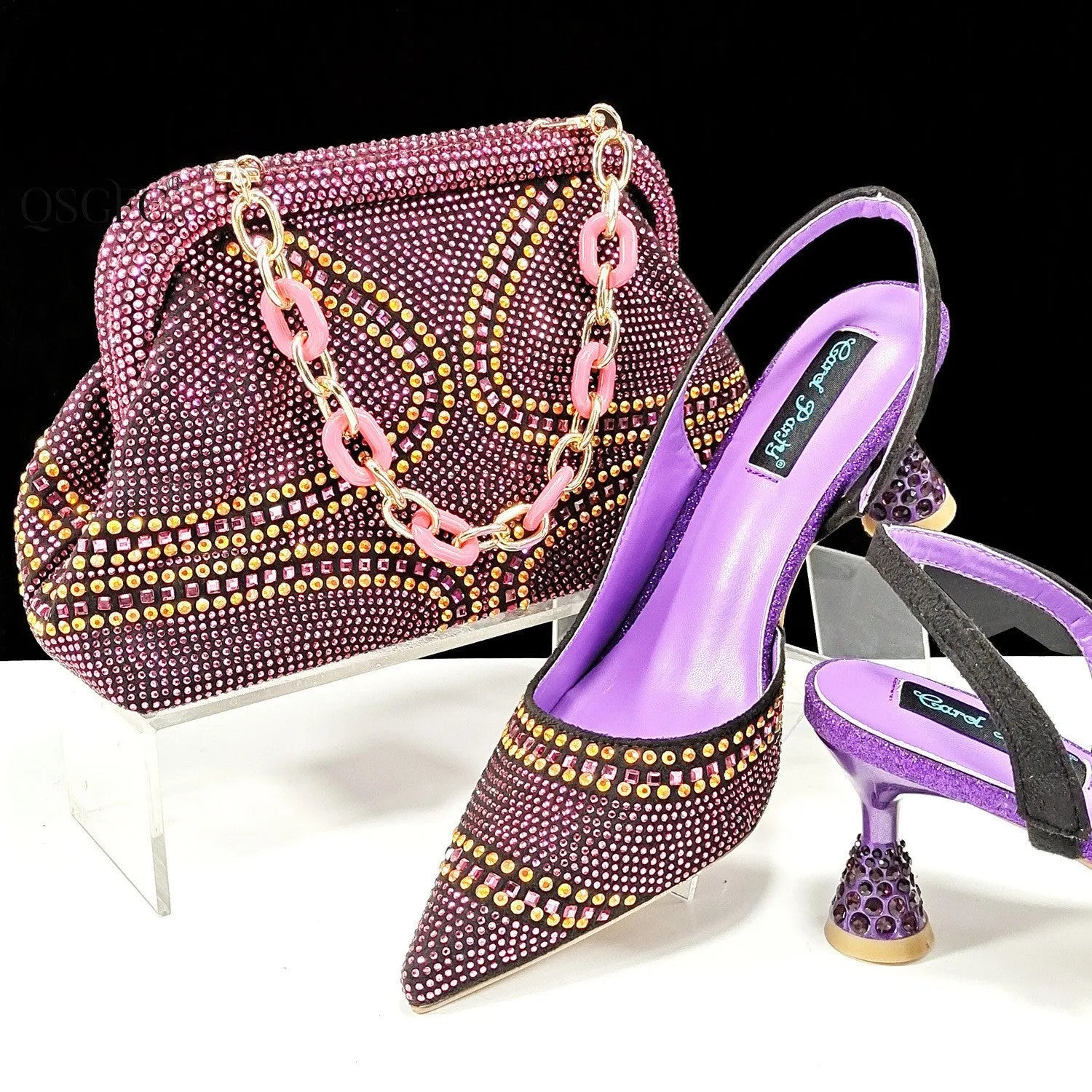 Women's pointed toe high heels with rhinestones and a matching small bag in synthetic leather.