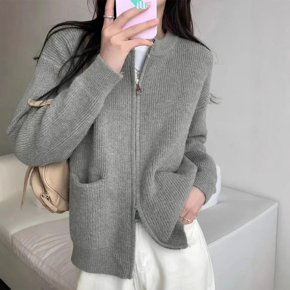 Beige viscose fibre long sleeve cardigan sweater coat laid flat, showing button front and soft texture.