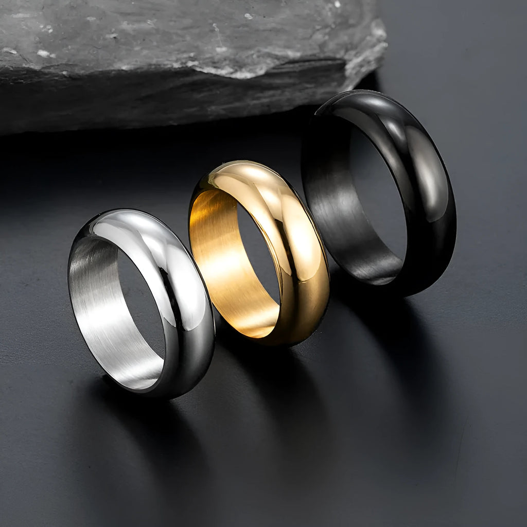 A glossy electroplated titanium steel ring shown in gold, black, and steel colour options on a plain background.
