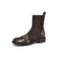 Women's black low heel Martin boots with lace-up front and belt buckle stitching detail on a round toe.