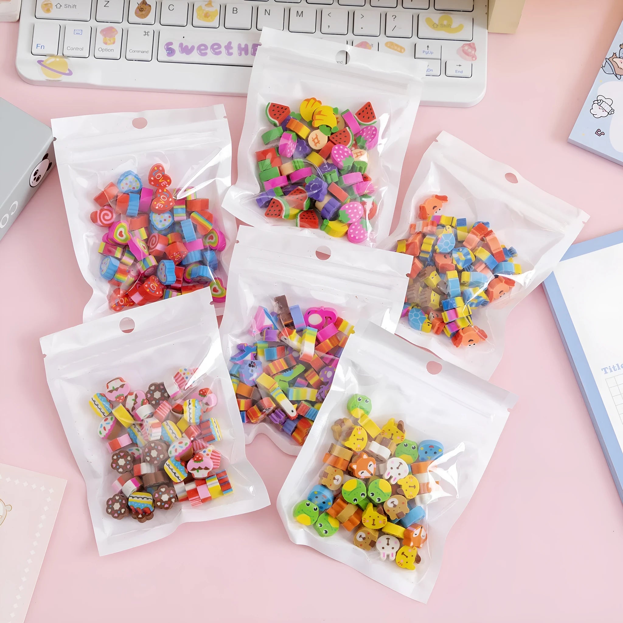 50 small cartoon fruit and animal themed rubber erasers in a pearlescent bag.