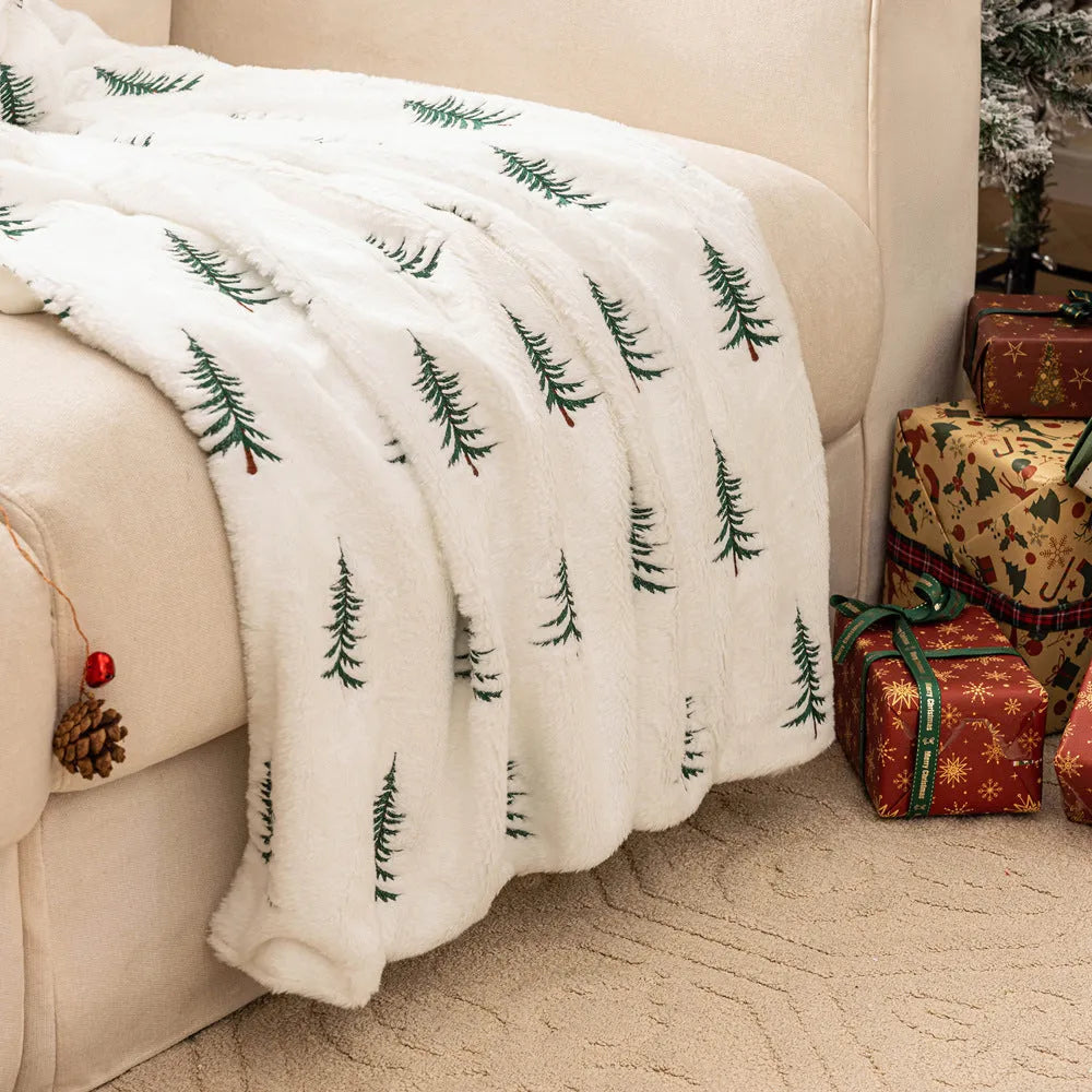 White polyester Christmas plush sofa blanket with embroidered Christmas tree on a sofa