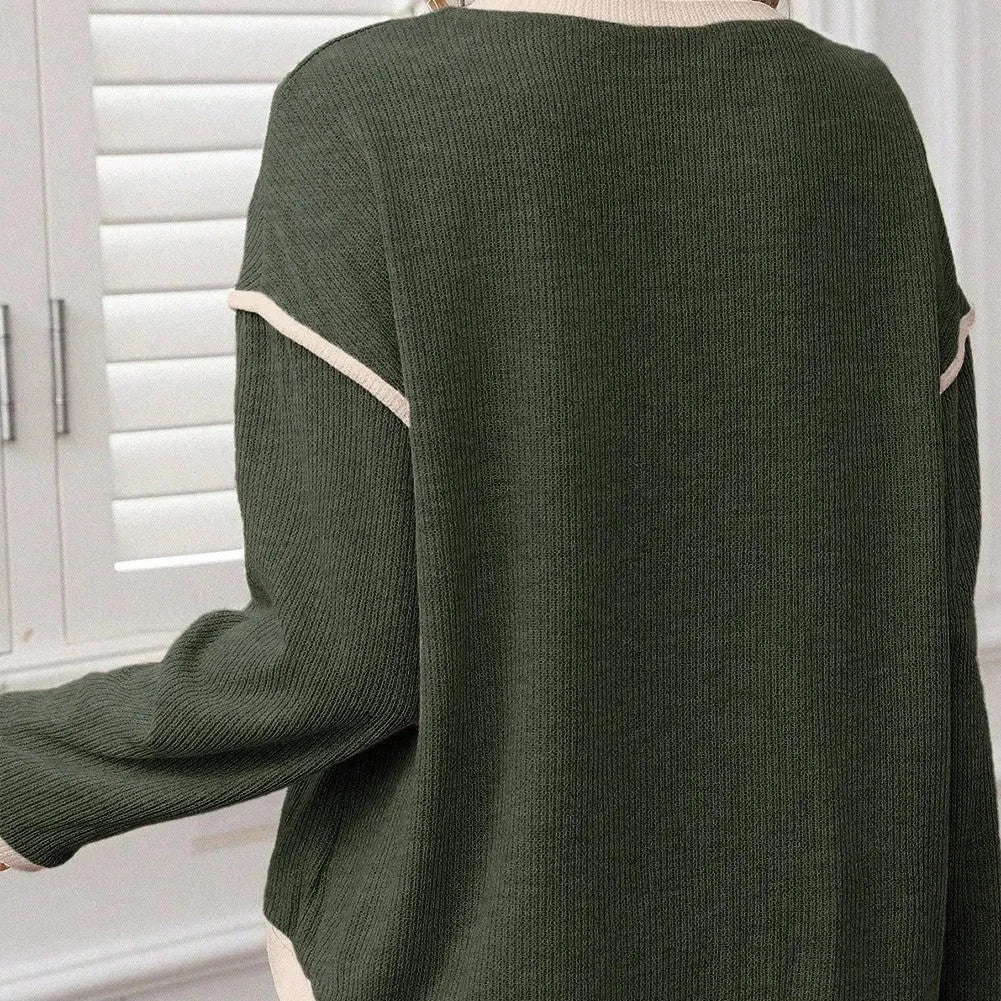 Beige loose knit top with green four leaf clover contrast trim and drop shoulders.