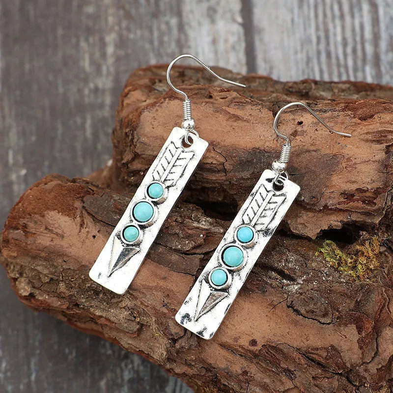 Long silver geometric earrings with turquoise inlay details on zinc alloy