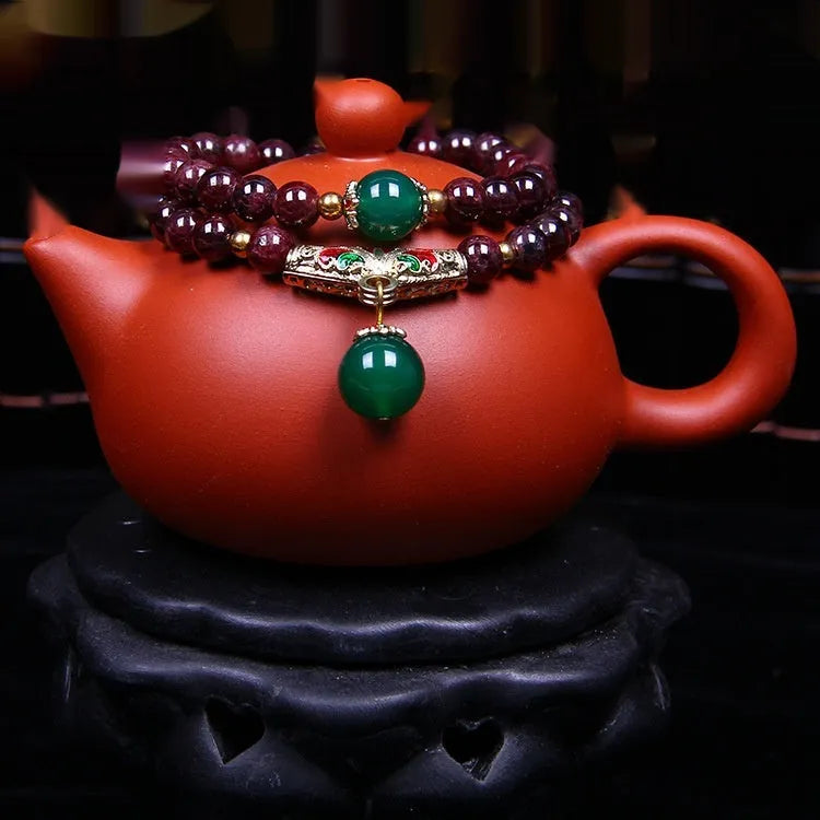 Women's natural garnet bracelet with 7mm beads, double ring closure and Golden Toad charm