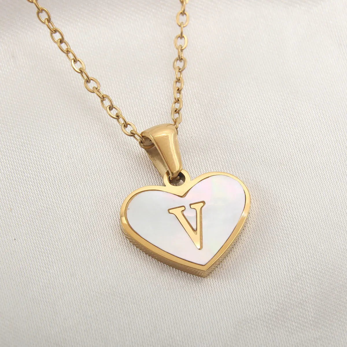 Gold plated heart necklace with white shell detail on an adjustable chain