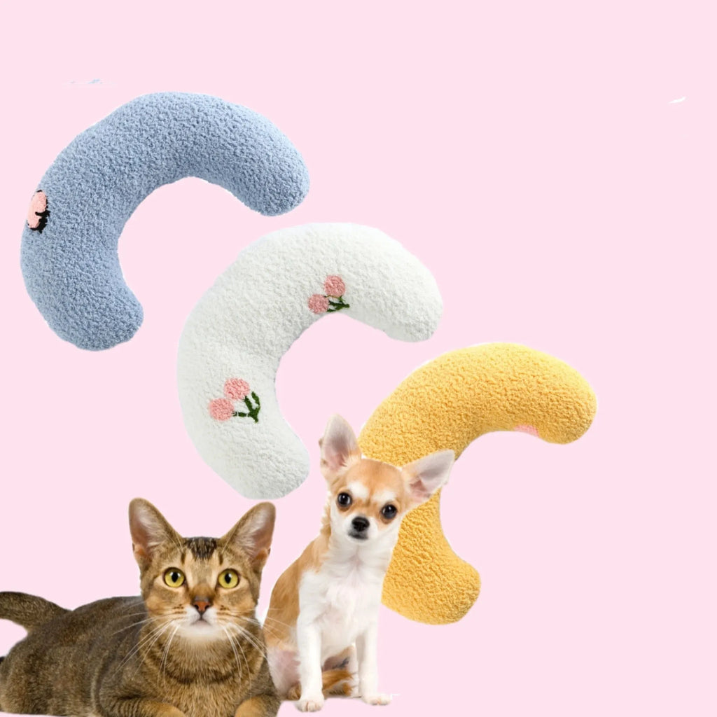 Small U-shaped plush pet pillow in blue for cats and small dogs, showing quilted faux fur texture.