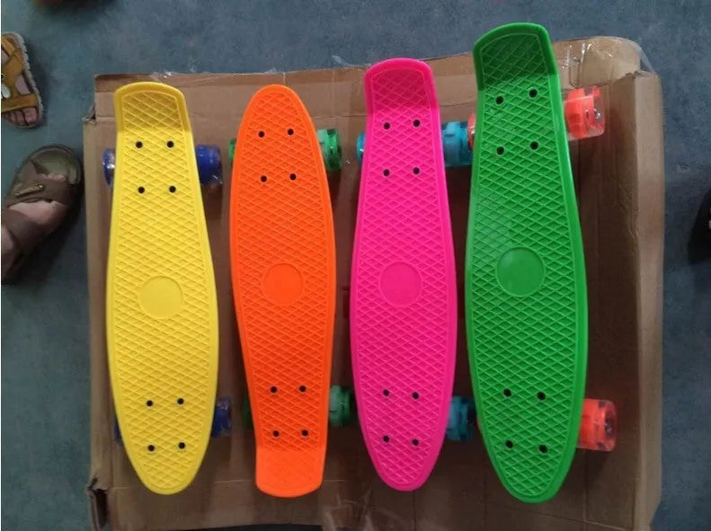 Four-wheel skateboard with blue PP deck, magnesium aluminium trucks, and flashing PU wheels on white background