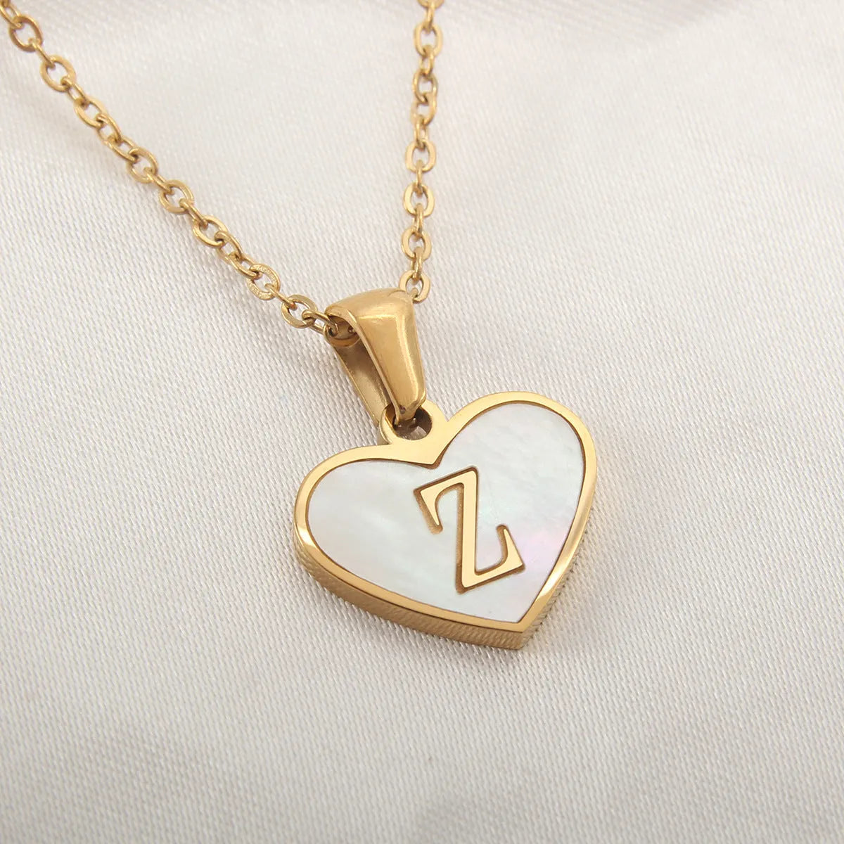 Gold plated heart necklace with white shell detail on an adjustable chain