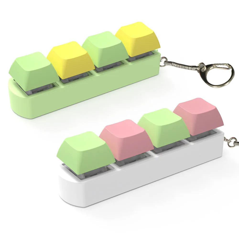 Compact 4-key mechanical keyboard switch tester on a desk, showing coloured ABS plastic construction.