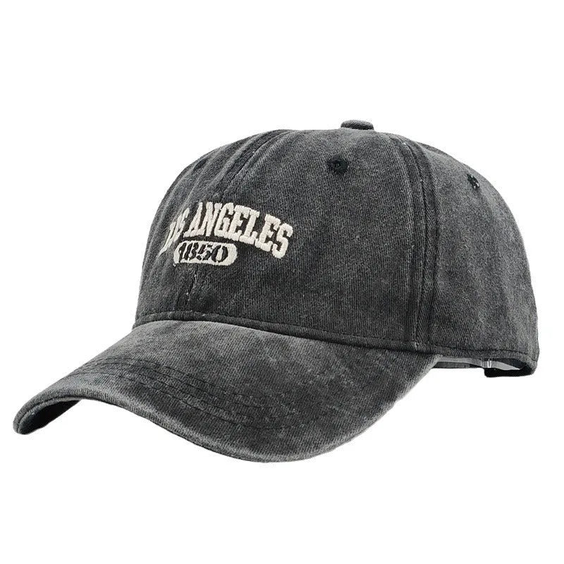 Retro personalised adjustable peaked cap showing distressed letters embroidery on conical crown