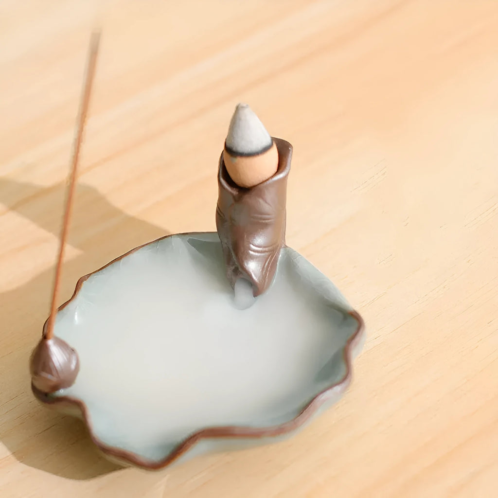 Square purple clay ceramic incense burner with lotus and plum blossom motifs