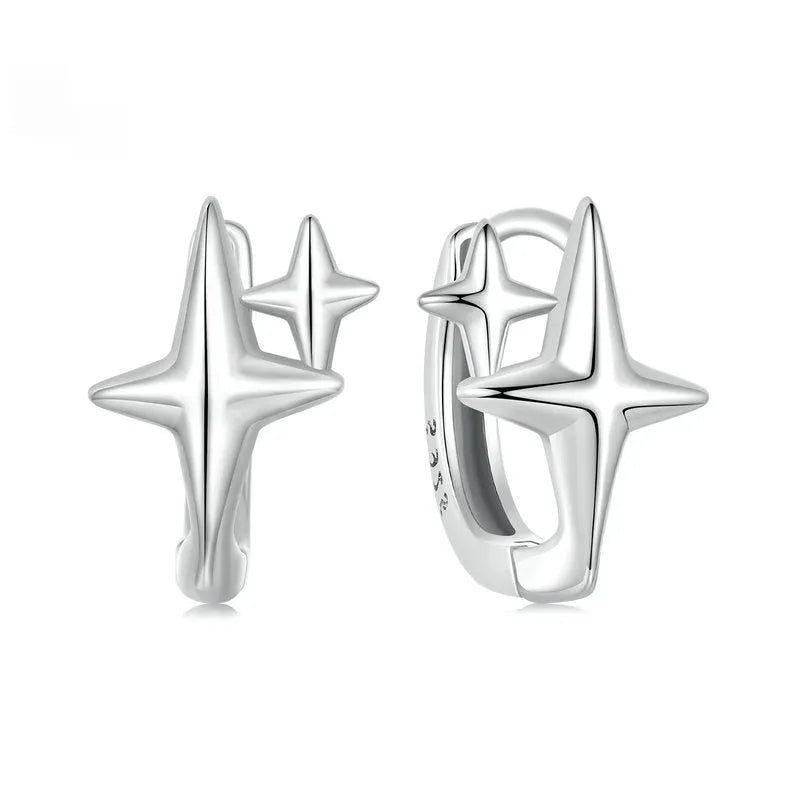Minimalist star design silver ear clip with XINGX detail on a plain background.