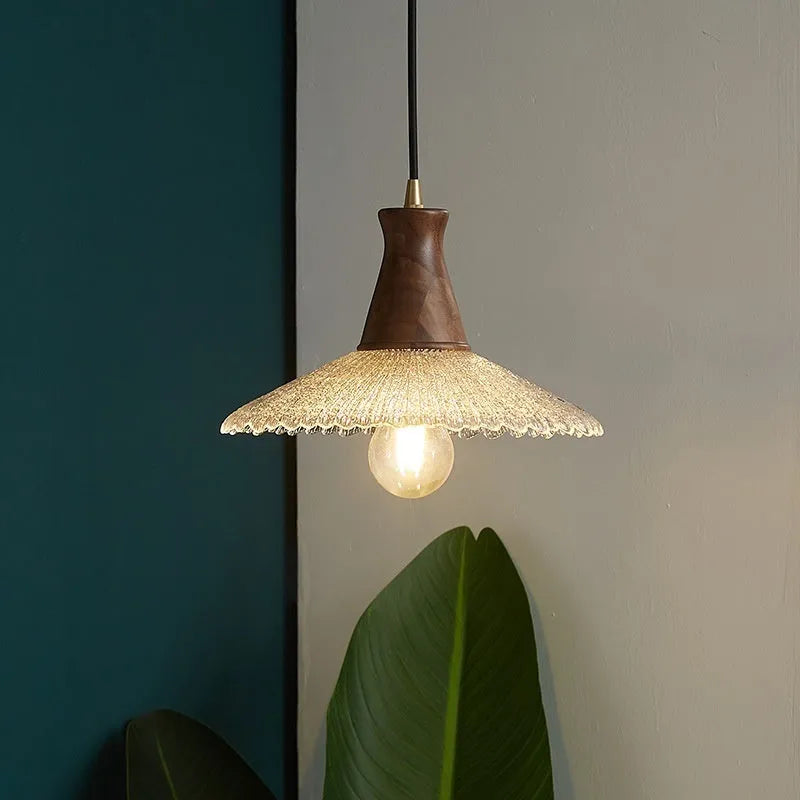 Retro-style brass and glass chandelier with a wooden frame hanging from a ceiling.