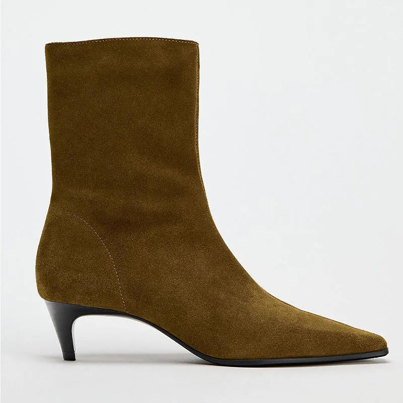Brown square toe women's boots with a side zipper and a mid stiletto heel on a wooden floor.