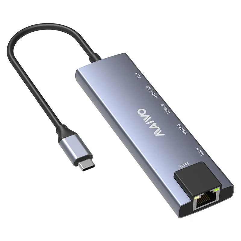 Aluminium Steam Deck six-in-one docking station with HDMI, USB, and Ethernet ports next to a handheld console.