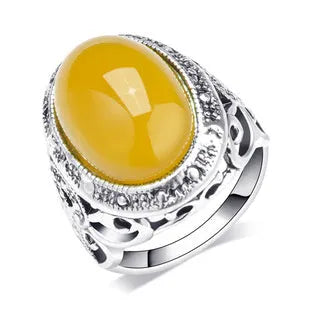 Retro geometric alloy ring in antique silver amber colour on a grey background.