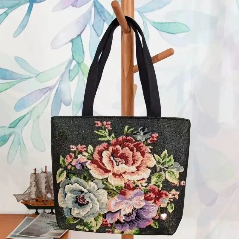 Canvas embroidery handbag with gold wire detail shown in an artistic colour design.