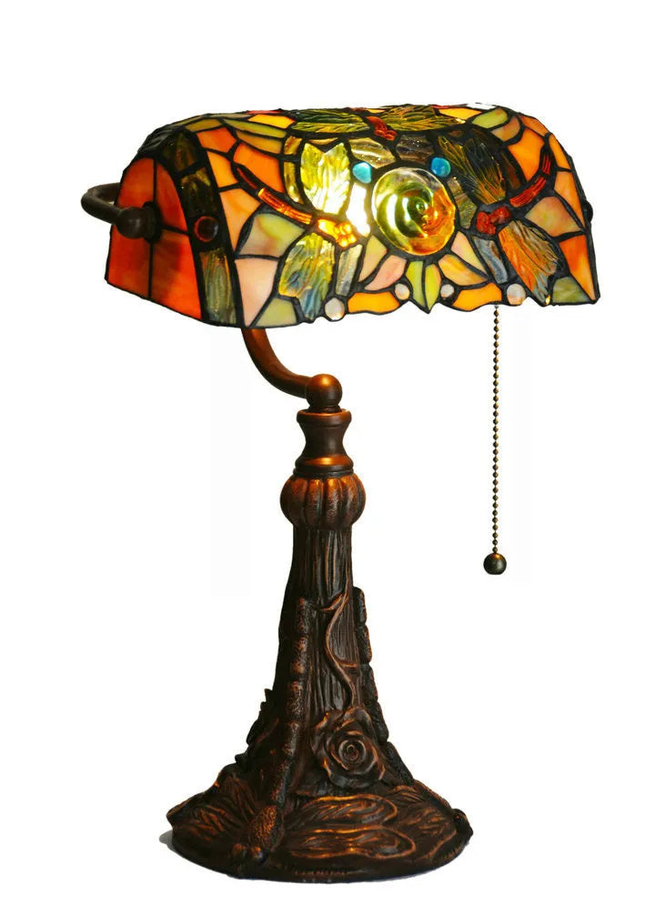 Tiffany table lamp with stained glass shade on wooden desk, 36cm tall with warm lighting