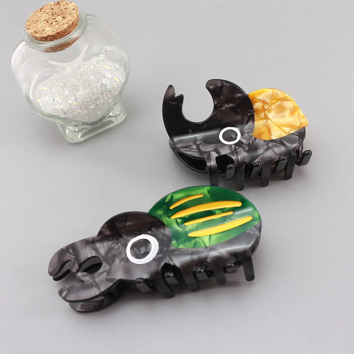 Handmade cellulose acetate insect brooch with beetle grip pin in green, orange, or white caterpillar designs