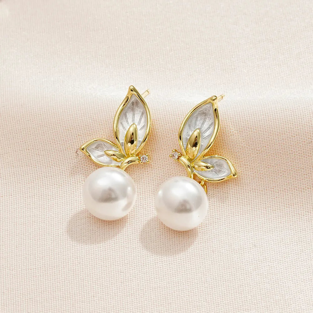 A pair of simple zircon butterfly stud earrings for women with copper electroplated finish.