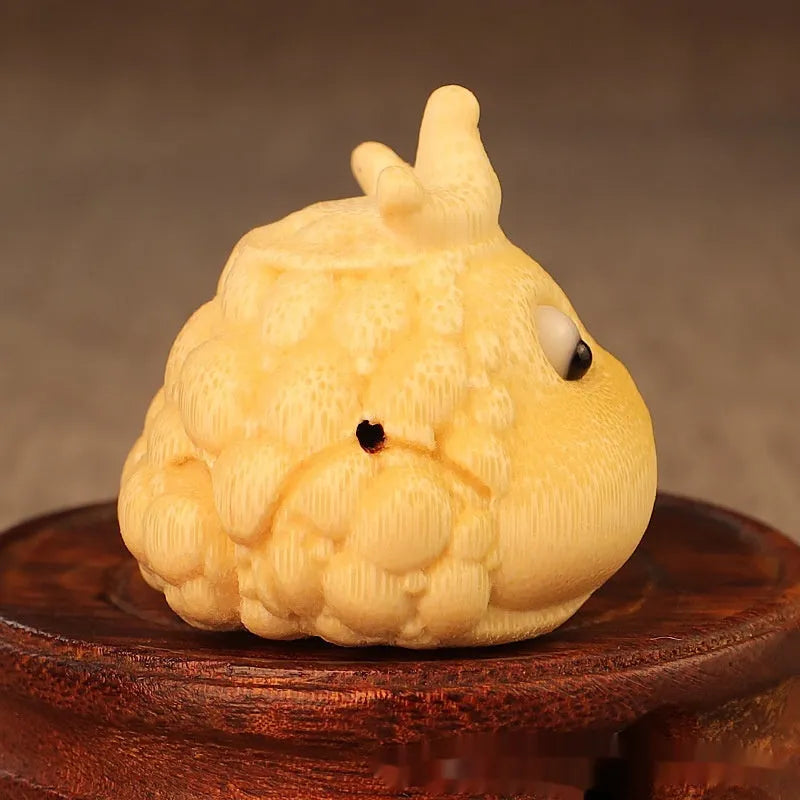 Solid bamboo carving of a Crown Princess Toad ornament with live eye design.