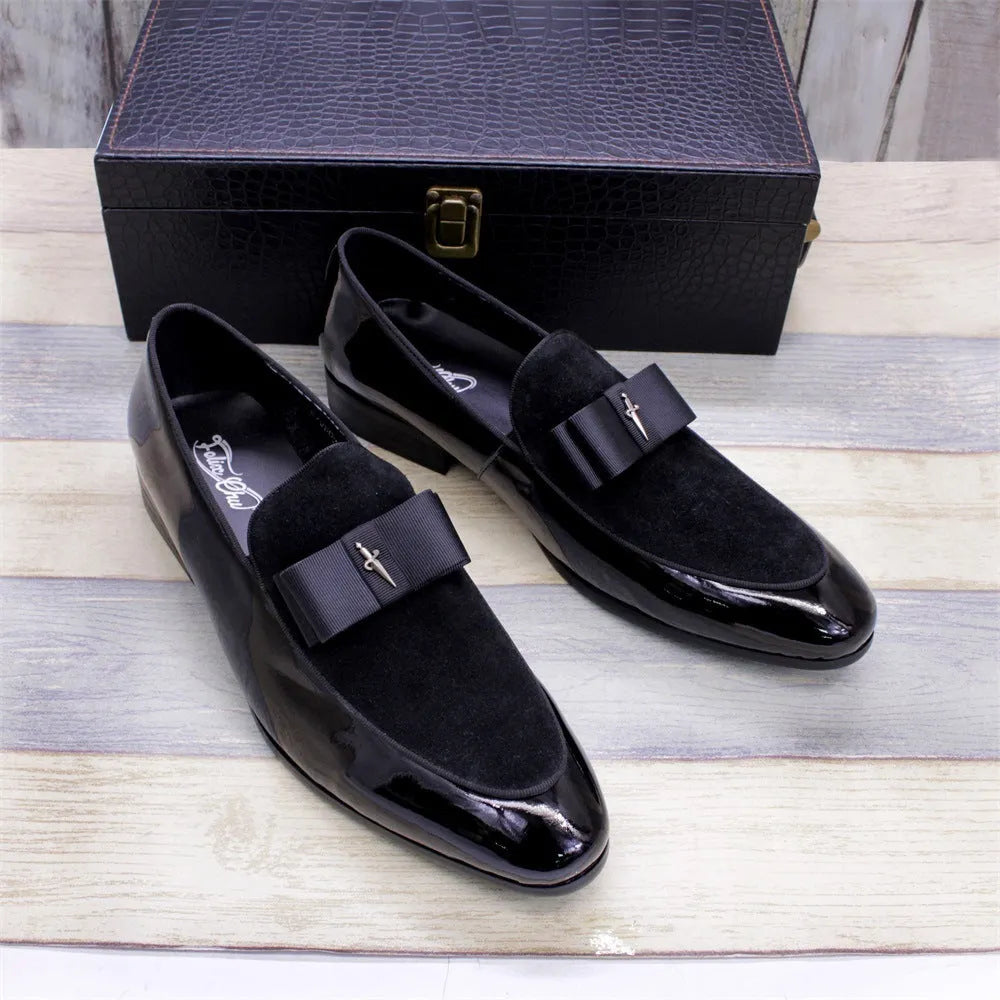 Men's black patent leather low-top shoes with a gold tassel detail on a white background.