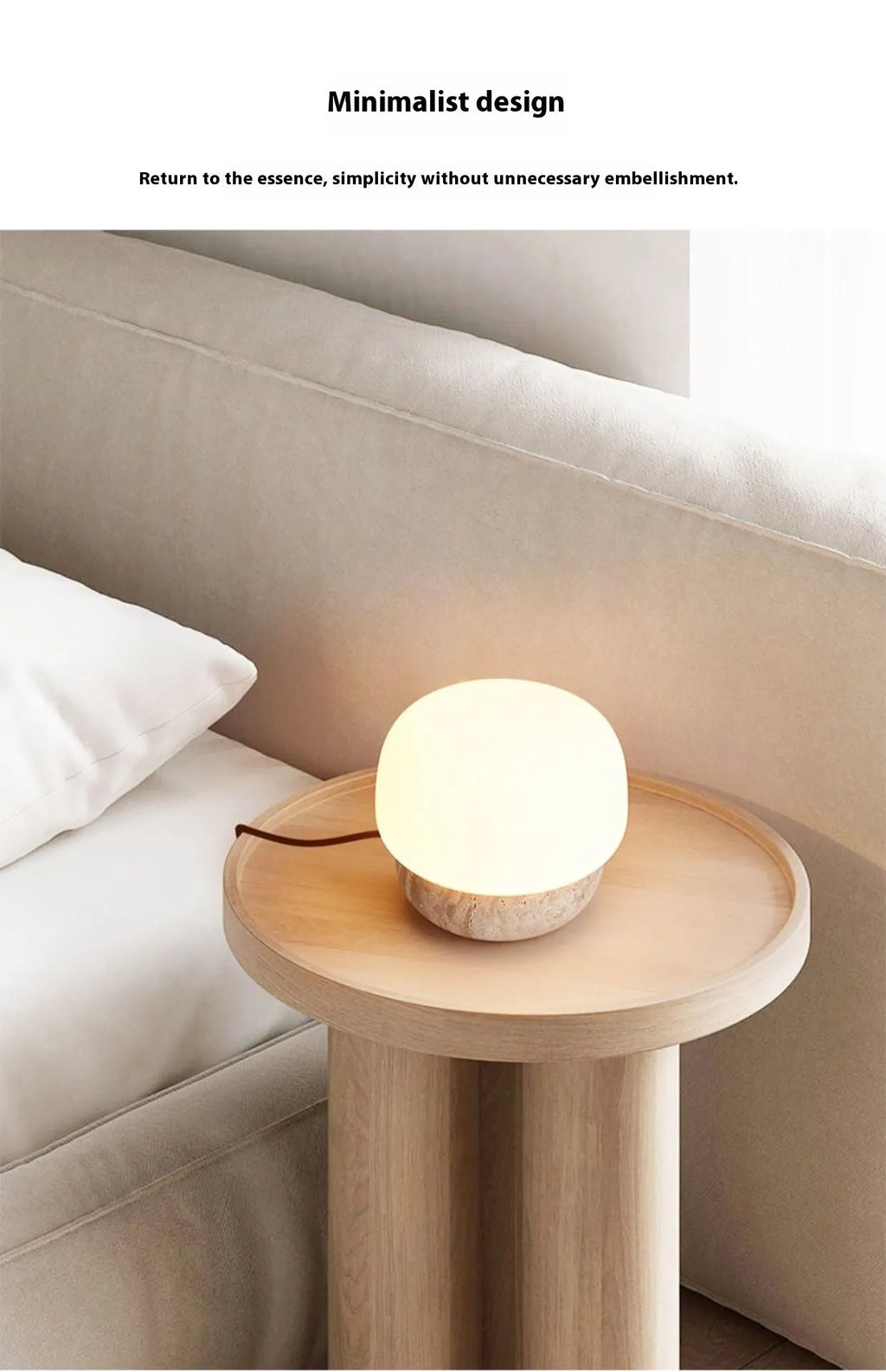 Cream-coloured retro style bedside lamp with a warm bulb on a table.