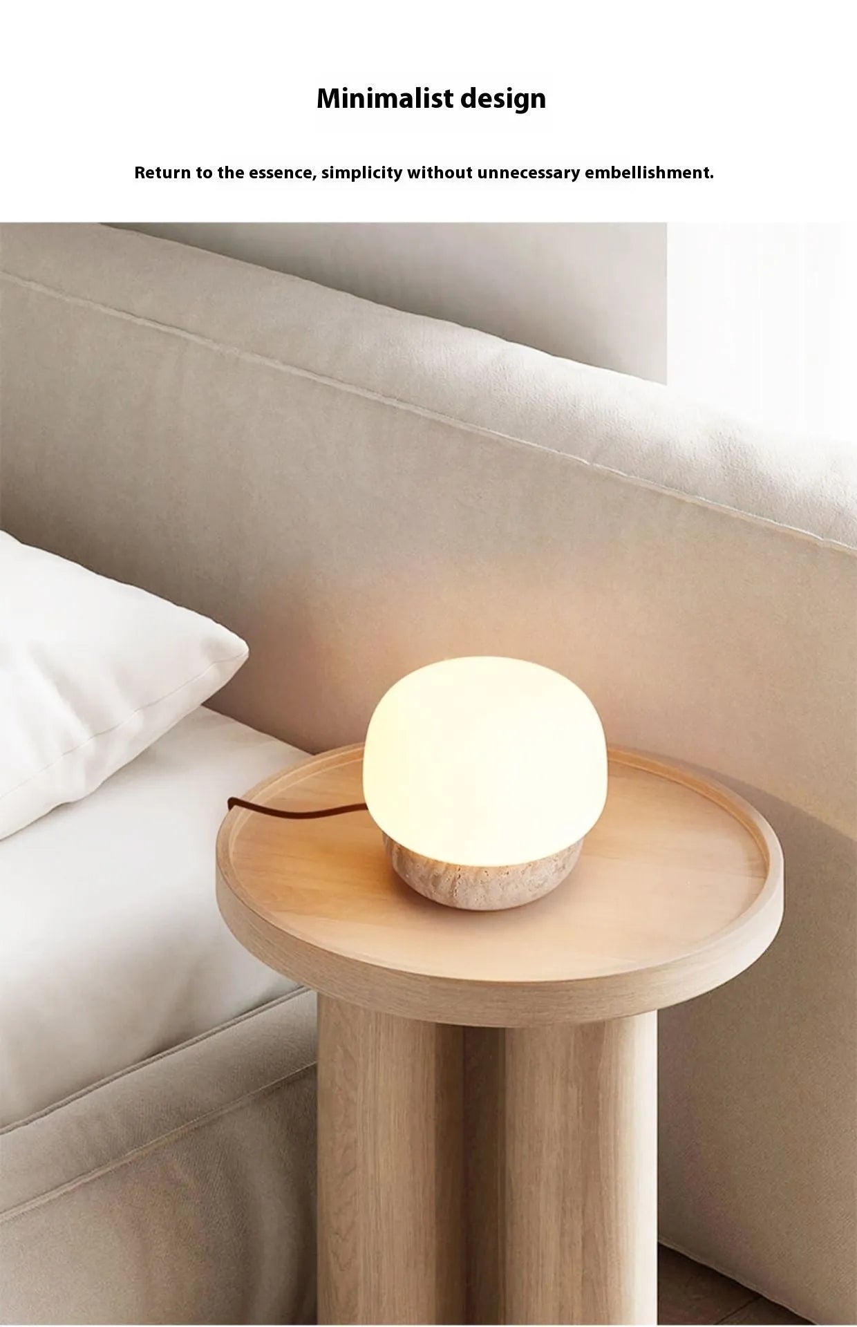 Cream-coloured retro style bedside lamp with a warm bulb on a table.