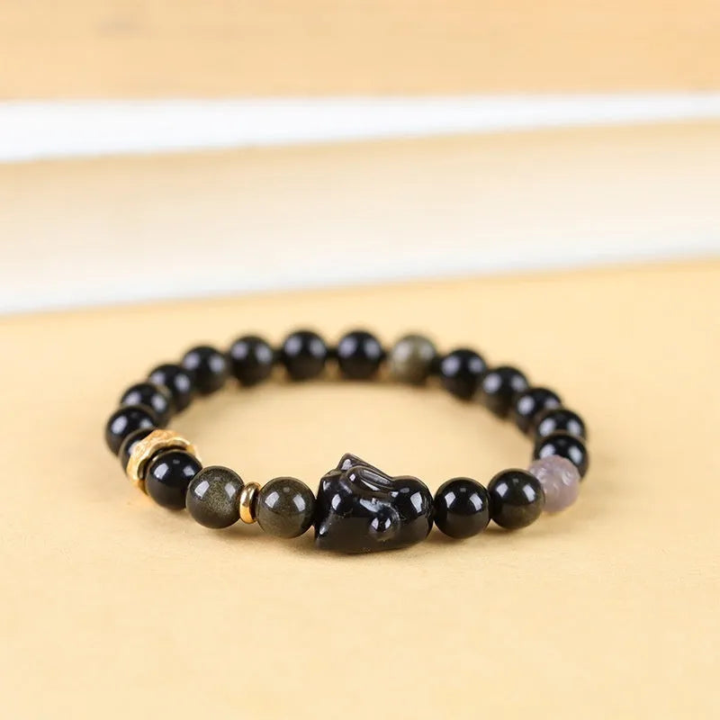 Handmade lying rabbit obsidian bracelet with Jin Yaoshi beads and brass details in national style.