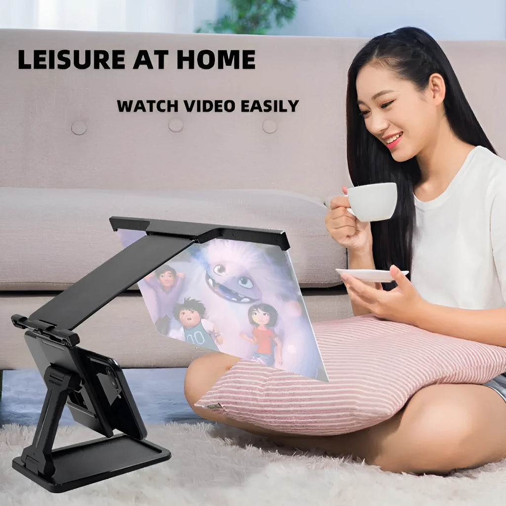 Black mobile phone screen amplifier with detachable phone holder on desktop surface