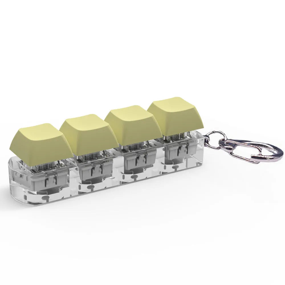 Compact 4-key mechanical keyboard switch tester on a desk, showing coloured ABS plastic construction.