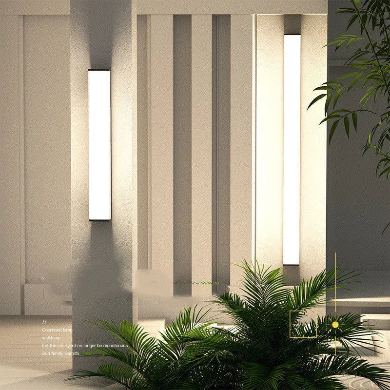 Stainless steel long strip outdoor wall light mounted on a wall, 60cm tall.