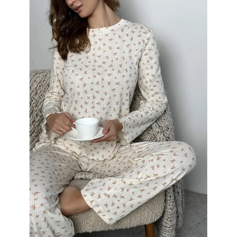 White floral print women's pyjama set with bell sleeve top and wide-leg trousers.