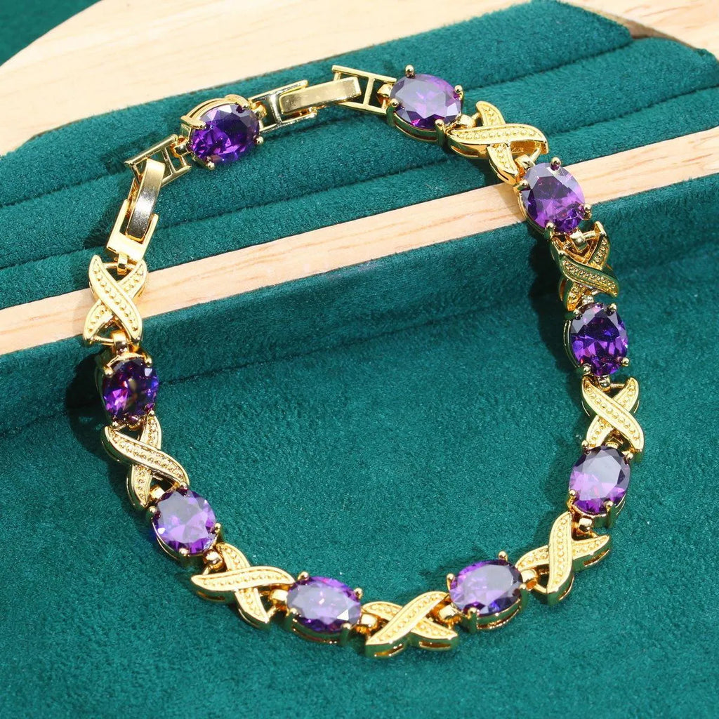 18k gold plated jewellery set with coloured cubic zirconia stones, showing necklace, earrings, ring, and bracelet.
