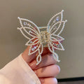 Butterfly-shaped alloy hair clip with rhinestone or pearl decorations, 6.7 cm wide