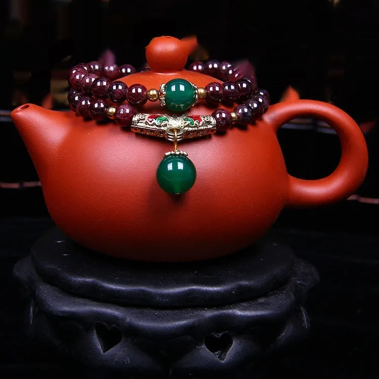 Women's natural garnet bracelet with 7mm beads, double ring closure and Golden Toad charm