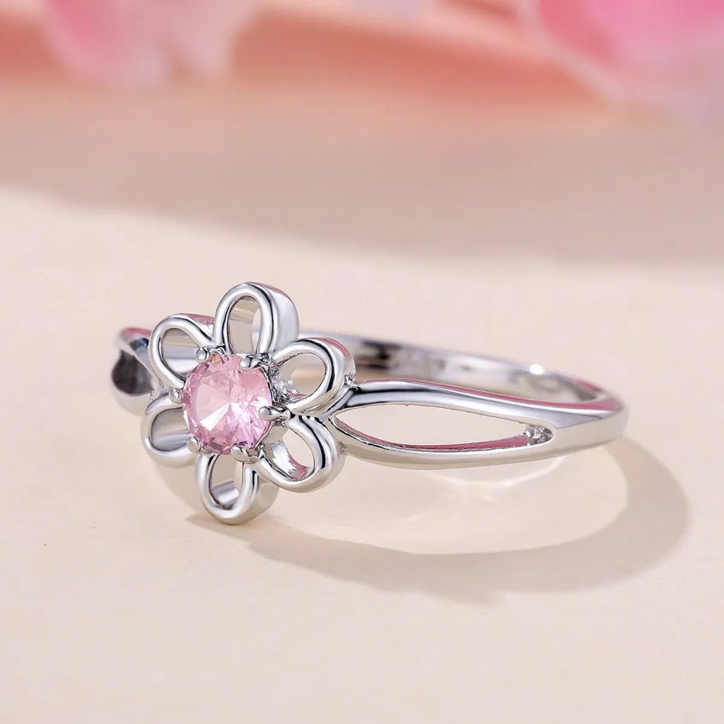 Lady's copper ring with hollowed flower design in platinum pink diamond colour showing size options