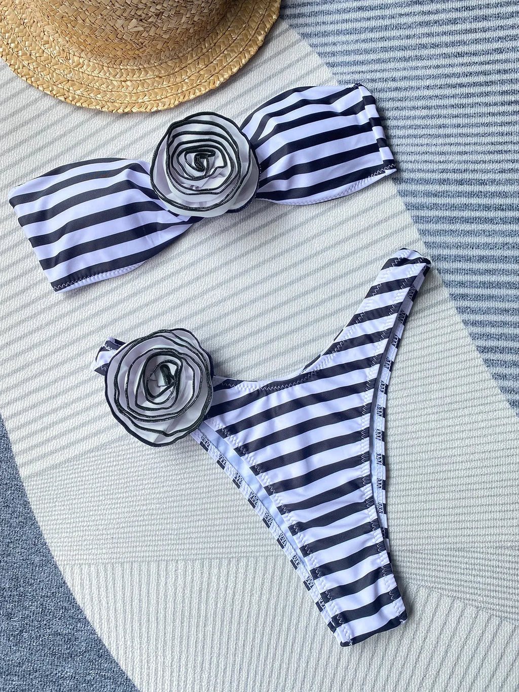 Black striped bikini set with flower detail tube top and split shorts on a mannequin.