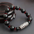 Black agate dzi bead bracelet with chalcedony stones and hand-woven design