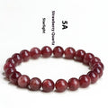 Natural cherry red strawberry quartz bracelet with geometric cut stones on wrist