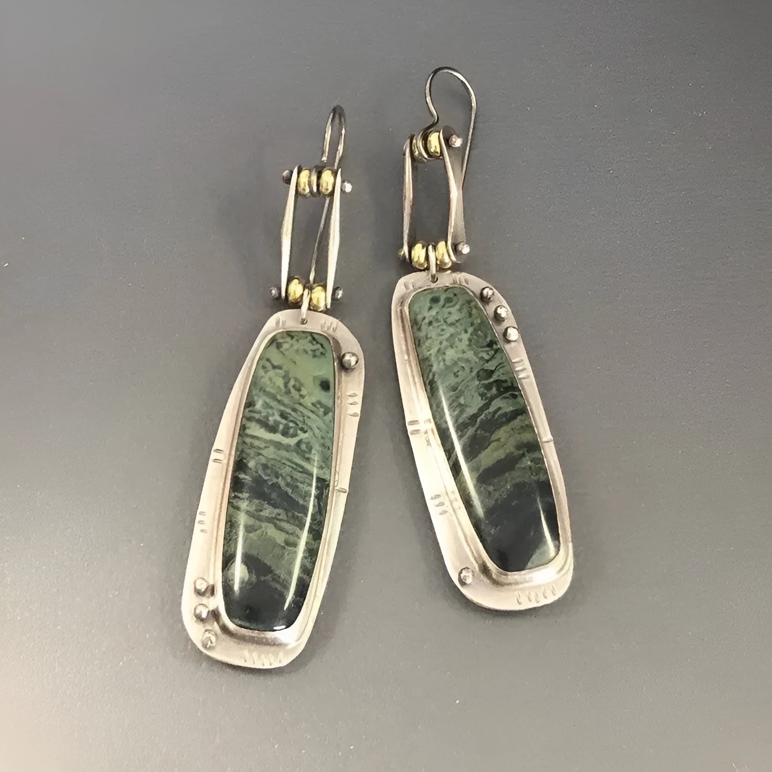 Geometric alloy earrings with two-tone marble pattern design on white background