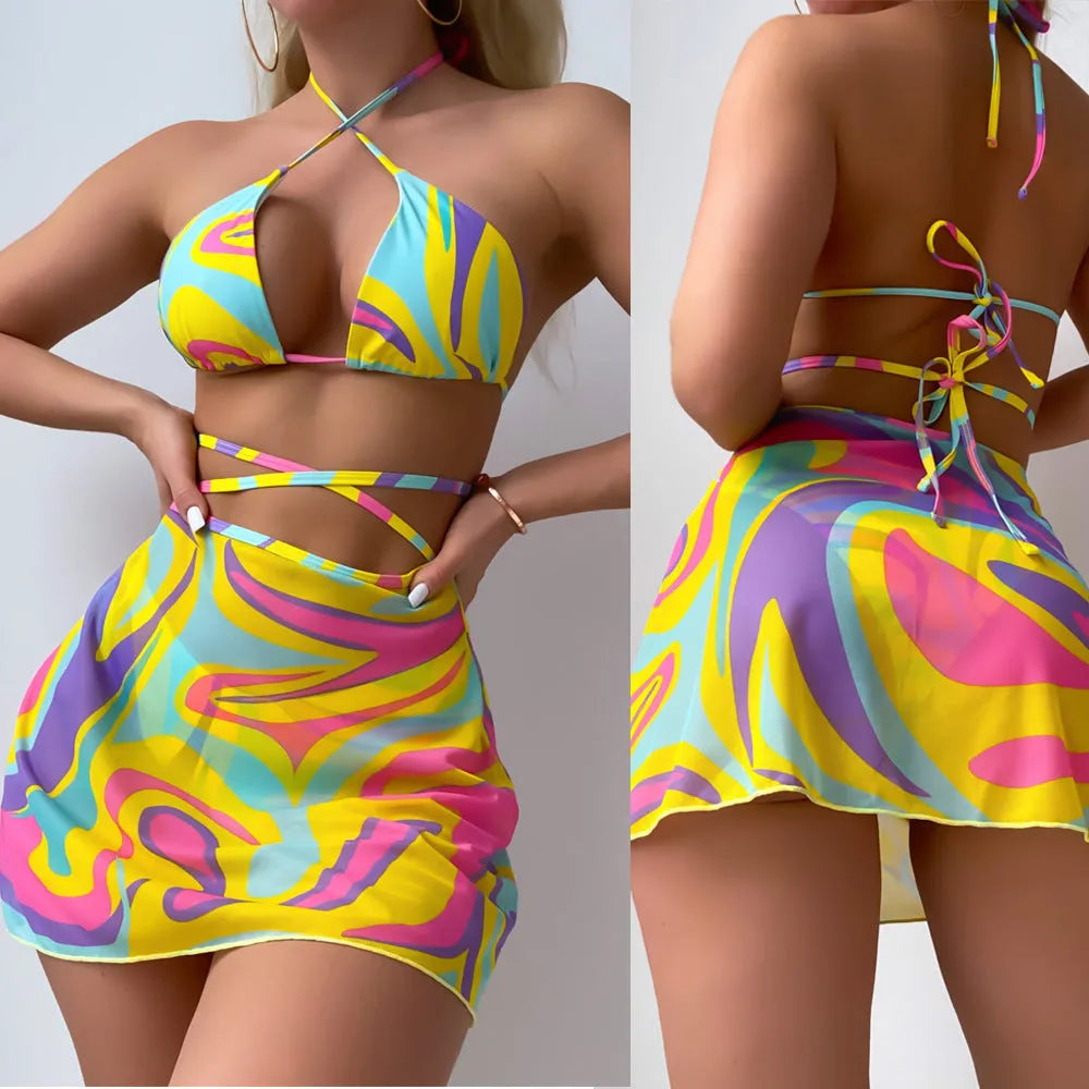 Yellow striped halter swimsuit for women with lace-up front, matching skirt, and shorts.