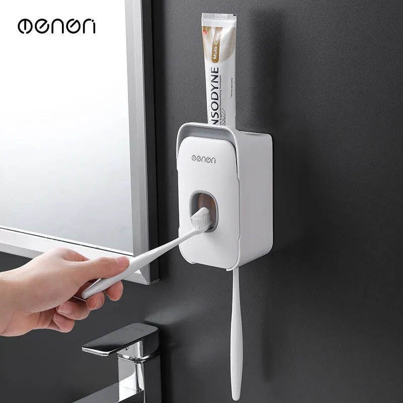 Blue automatic toothpaste dispenser mounted on bathroom wall with one-touch dispensing mechanism