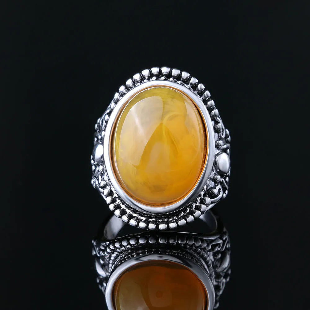 Retro geometric alloy ring in antique silver amber colour on a grey background.