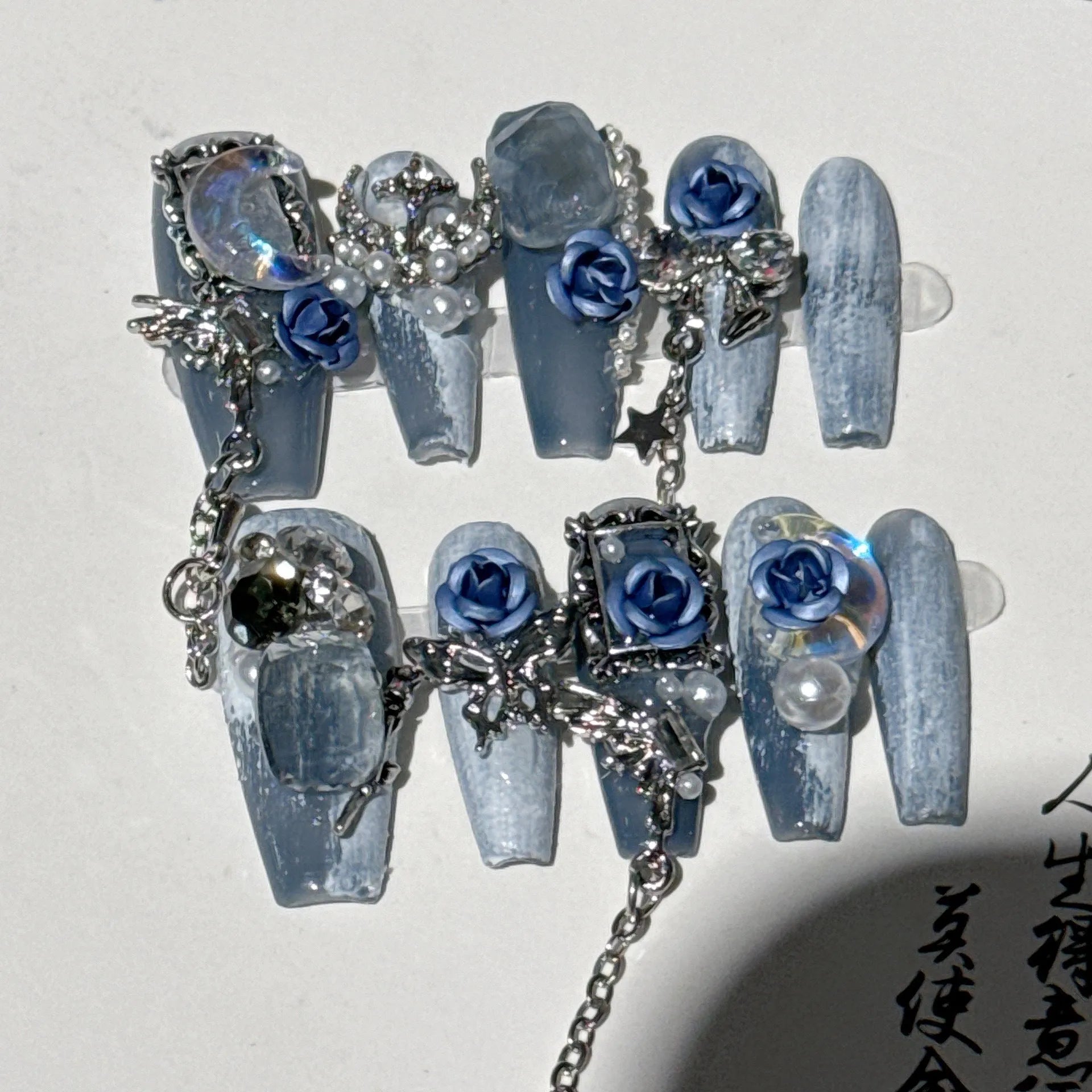 Blue evening manicure set with rose pattern on plastic nail armour suit