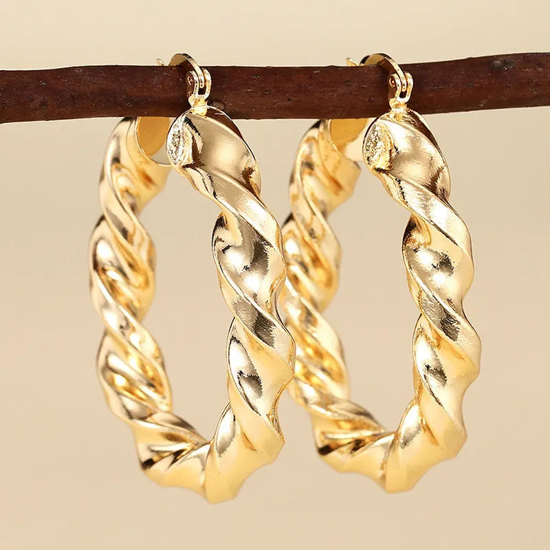 Geometric ring and line design drop-shaped clip-on earrings for women in copper with electroplated finish.