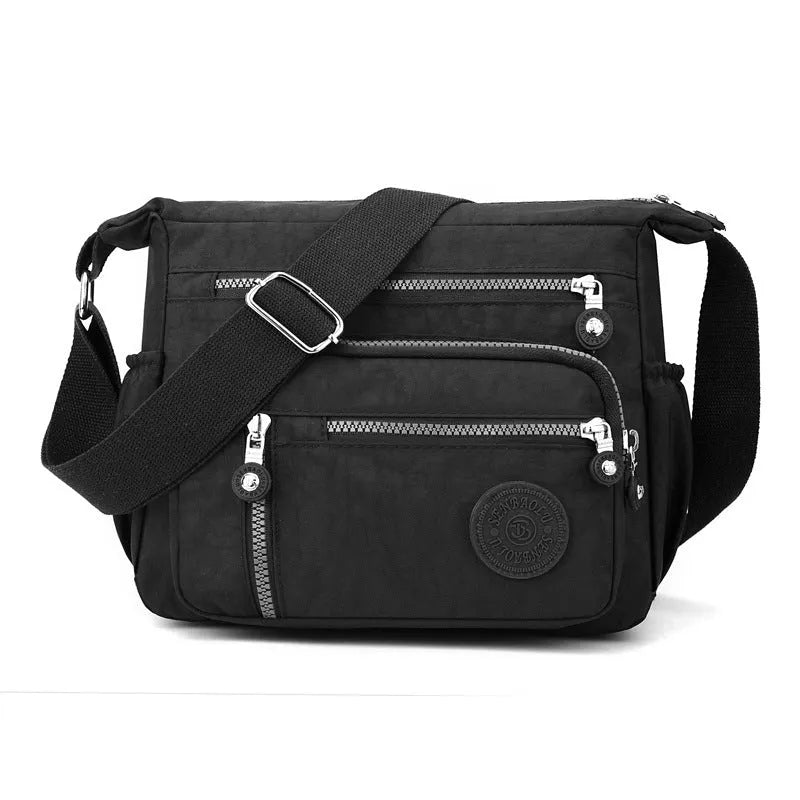 Lightweight nylon shoulder messenger bag in square vertical shape with single strap.