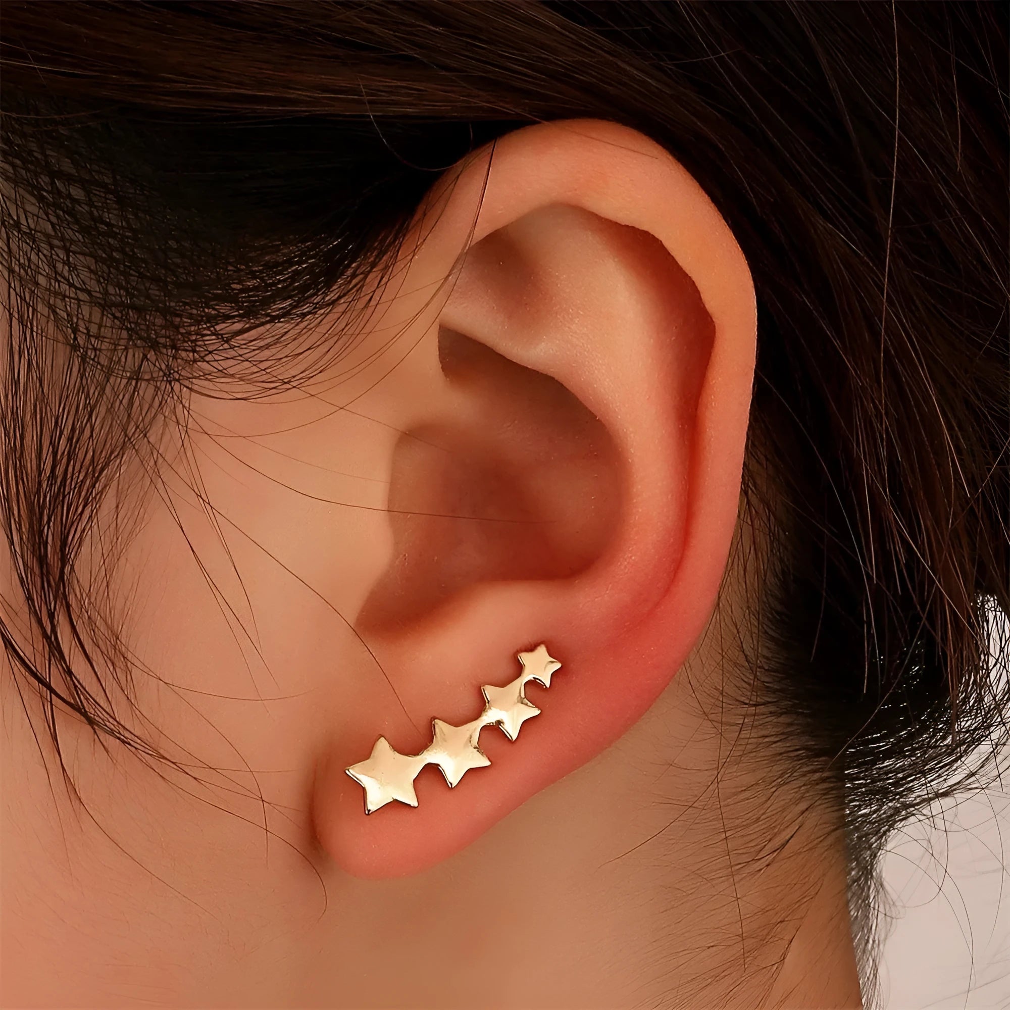 A pair of gold-coloured copper leaf-shaped clip-on earrings for women.