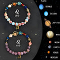 Two natural stone beaded bracelets with zodiac designs on a flat surface
